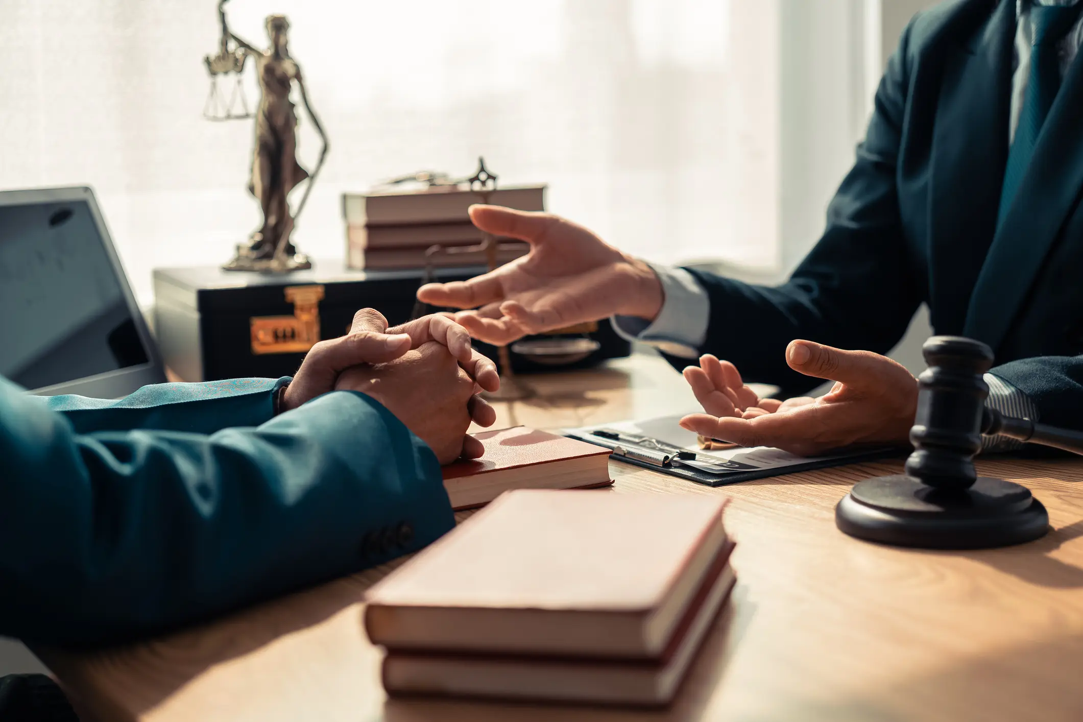 Two people discussing at a lawyer's desk.